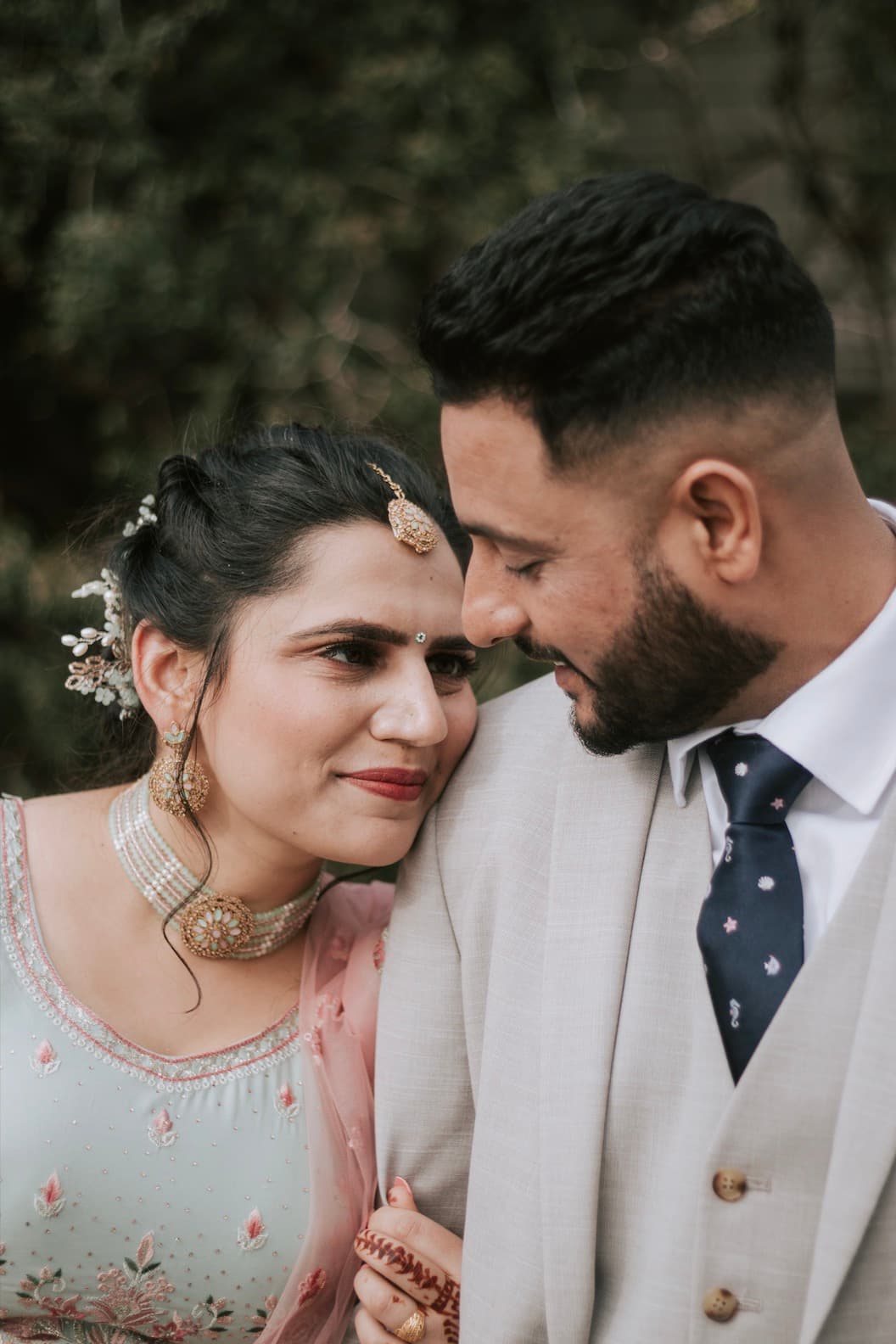 Bride and groom framed by evening lights