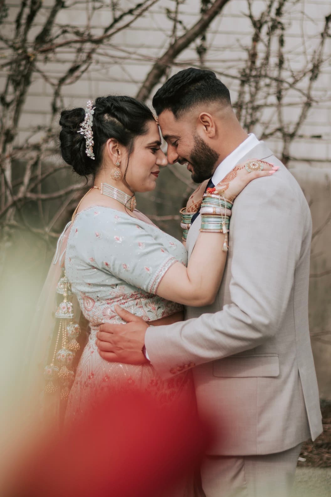 Couple walking through a vineyard at sunset
